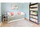 Bright bedroom featuring a daybed with cozy pillows, a stylish rug, and a bookshelf filled with books at 65 Millet Ct, Danville, IN 46122
