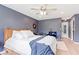 Comfortable bedroom featuring wood floors, a ceiling fan, and a plush bed with white linens and a blue throw at 65 Millet Ct, Danville, IN 46122