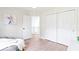 Well-lit bedroom featuring wood floors, an open closet, and a comfortable beanbag chair at 65 Millet Ct, Danville, IN 46122