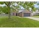 Two-story brick home featuring an attached two-car garage and well-maintained front lawn at 65 Millet Ct, Danville, IN 46122