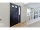 Welcoming front door with sidelight and transom window leads into a bright foyer with staircase at 65 Millet Ct, Danville, IN 46122