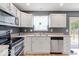 Functional kitchen with stainless steel appliances and ample natural light from the window above the sink at 65 Millet Ct, Danville, IN 46122