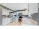 Well-lit kitchen featuring stainless steel appliances, white cabinets, and light wood-look flooring at 65 Millet Ct, Danville, IN 46122