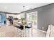 Bright kitchen and dining area featuring white cabinets and modern appliances, opens to patio at 65 Millet Ct, Danville, IN 46122