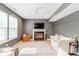 Bright living room with fireplace, ceiling fan, and large windows offering ample natural light at 65 Millet Ct, Danville, IN 46122