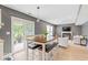 Open floor plan with dining table, living area, and sliding glass doors leading to the patio at 65 Millet Ct, Danville, IN 46122