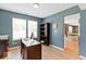 Home office with views through the windows to the outdoors, and access to the kitchen at 65 Millet Ct, Danville, IN 46122