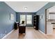 Well-lit home office with natural light, wood floors, and direct access to the kitchen at 65 Millet Ct, Danville, IN 46122