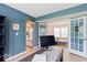Bright home office with French doors leading to a lounge area and direct access to the kitchen at 65 Millet Ct, Danville, IN 46122
