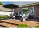 Inviting outdoor deck with a fire pit table, comfortable seating, and a grill for entertaining at 6649 Braemar S Ave, Noblesville, IN 46062