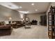Inviting basement living area with comfortable brown sofas, decorative pillows, and modern decor at 6649 Braemar S Ave, Noblesville, IN 46062