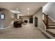 Spacious basement with plush carpeting, ample lighting, and a cozy seating area with brown sofas at 6649 Braemar S Ave, Noblesville, IN 46062