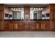 Large bathroom vanity featuring dual sinks, dark granite countertops, and ample storage at 6649 Braemar S Ave, Noblesville, IN 46062