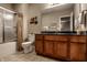 Bathroom featuring a vanity with a black countertop, wooden cabinets, and a shower with a curtain at 6649 Braemar S Ave, Noblesville, IN 46062