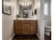 A traditional bathroom with a wood vanity and dark-tiled flooring at 6649 Braemar S Ave, Noblesville, IN 46062