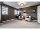 Cozy bedroom featuring two windows, two cushioned chairs, accent lighting, and neutral decor at 6649 Braemar S Ave, Noblesville, IN 46062