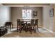 Basement dining area featuring a wooden table and chairs, complemented by a window and decorative art at 6649 Braemar S Ave, Noblesville, IN 46062