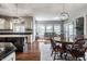 Spacious dining room showcasing hardwood floors, backyard views and chandelier lighting, adjacent to the kitchen at 6649 Braemar S Ave, Noblesville, IN 46062
