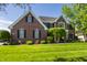 Charming brick two-story home with lush green lawn and well-maintained landscaping at 6649 Braemar S Ave, Noblesville, IN 46062
