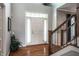 Bright foyer with hardwood floors, staircase, and elegant white front door with sidelights at 6649 Braemar S Ave, Noblesville, IN 46062