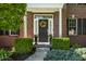 Inviting front entrance with brick facade, columns, flower pots, and decorative wreath at 6649 Braemar S Ave, Noblesville, IN 46062