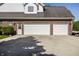 Attached two-car garage featuring brick facade, white doors, and a concrete driveway at 6649 Braemar S Ave, Noblesville, IN 46062