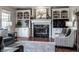 Stylish living room with fireplace, built-in cabinets, hardwood floors, and elegant decor at 6649 Braemar S Ave, Noblesville, IN 46062