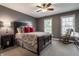 Comfortable main bedroom with a ceiling fan, neutral tones, and lots of natural light at 6649 Braemar S Ave, Noblesville, IN 46062