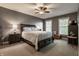 Inviting main bedroom with two windows, a ceiling fan, and neutral carpet at 6649 Braemar S Ave, Noblesville, IN 46062