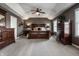 Expansive main bedroom suite with a tray ceiling, plush carpet, and a full set of wood bedroom furniture at 6649 Braemar S Ave, Noblesville, IN 46062