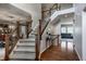 Elegant staircase with carpeted steps, wood railing, and iron spindles leading to the second floor at 6649 Braemar S Ave, Noblesville, IN 46062