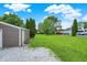View of a spacious backyard with lush green grass and surrounding trees at 6838 Five Points Rd, Indianapolis, IN 46259
