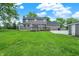 Spacious backyard featuring a deck, well-maintained lawn, and detached garages at 6838 Five Points Rd, Indianapolis, IN 46259