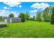 Lush backyard featuring a detached garage, perfect for outdoor activities and storage at 6838 Five Points Rd, Indianapolis, IN 46259