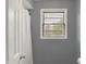Bathroom featuring a window with blinds and a white shower curtain at 6838 Five Points Rd, Indianapolis, IN 46259