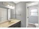 Bathroom featuring a vanity, white sink, and door to toilet and shower at 6838 Five Points Rd, Indianapolis, IN 46259