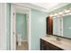 A clean bathroom features bright blue walls, a cream countertop, and a classic vanity at 6838 Five Points Rd, Indianapolis, IN 46259