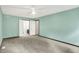 A bright bedroom with an ensuite bathroom features neutral carpeting and a ceiling fan at 6838 Five Points Rd, Indianapolis, IN 46259