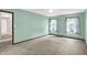 A spacious bedroom with neutral carpeting and two windows offers serene space with a ceiling fan at 6838 Five Points Rd, Indianapolis, IN 46259