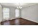 Bright, spacious dining room with hardwood floors, neutral walls, and two windows providing ample natural light at 6838 Five Points Rd, Indianapolis, IN 46259