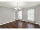 The dining room features wood floors, gray walls, white trim, and a chandelier, with two windows at 6838 Five Points Rd, Indianapolis, IN 46259