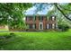 Charming two-story brick home with manicured lawn and mature trees offering a welcoming curb appeal at 6838 Five Points Rd, Indianapolis, IN 46259