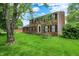 Charming brick home with tidy landscaping, inviting front lawn, and a delightful porch swing for relaxing at 6838 Five Points Rd, Indianapolis, IN 46259