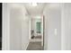 The long hallway features gray walls and carpet, with various entryways to the home's bedrooms at 6838 Five Points Rd, Indianapolis, IN 46259