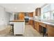 Kitchen with stainless steel appliances, a large island with seating, and a light tile floor at 6838 Five Points Rd, Indianapolis, IN 46259