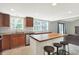 Open-concept kitchen featuring an island with seating, stainless steel appliances, and lots of natural light at 6838 Five Points Rd, Indianapolis, IN 46259