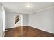 Spacious living room featuring hardwood floors, neutral walls, and an open entryway with stairs at 6838 Five Points Rd, Indianapolis, IN 46259