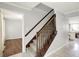 Carpeted staircase with wooden banister and neutral walls connecting different levels of the home at 6838 Five Points Rd, Indianapolis, IN 46259