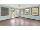 Bright sunroom features multiple windows, light blue walls, and a ceiling fan at 6838 Five Points Rd, Indianapolis, IN 46259