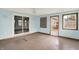 The sunroom with sliding glass door, white ceiling fan, and access to the backyard at 6838 Five Points Rd, Indianapolis, IN 46259